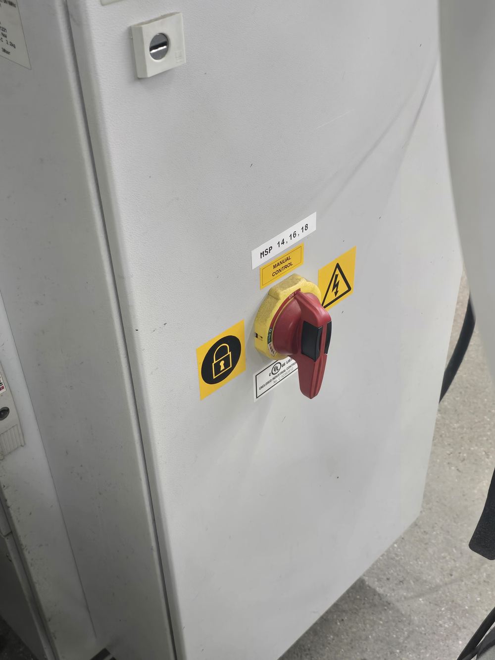 A second rotary disconnect on a white floor cabinet beside the welder, labelled MSP 14 16 18.