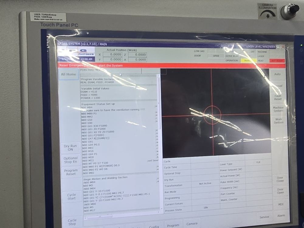 The touch panel in cold-start state with a full-width red bar reading Reset Emergency Stop to start the System.