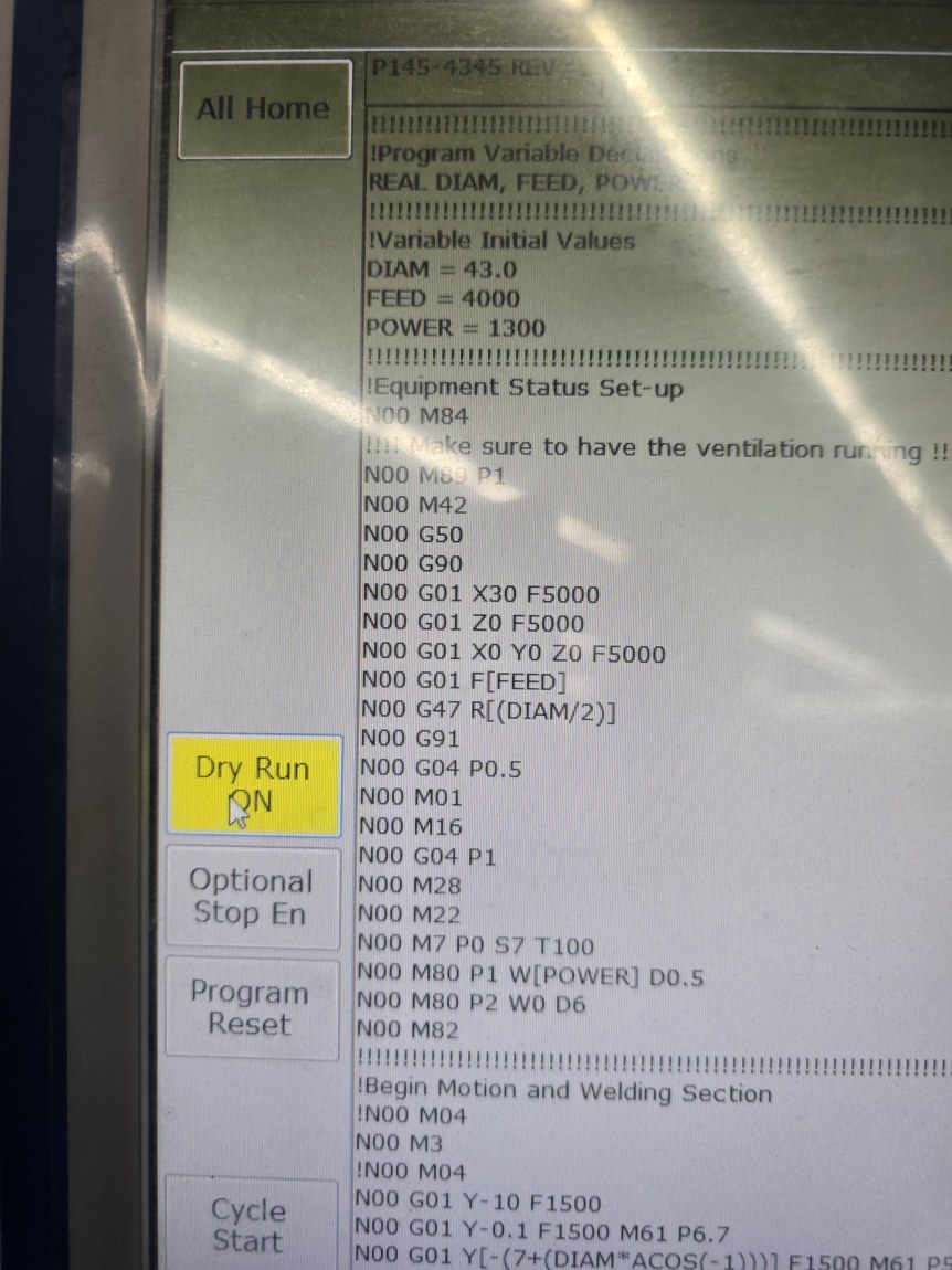 The touch panel left rail with Dry Run ON highlighted bright yellow and the mouse cursor on it; All Home above, Optional Stop En, Program Reset and Cycle Start below.