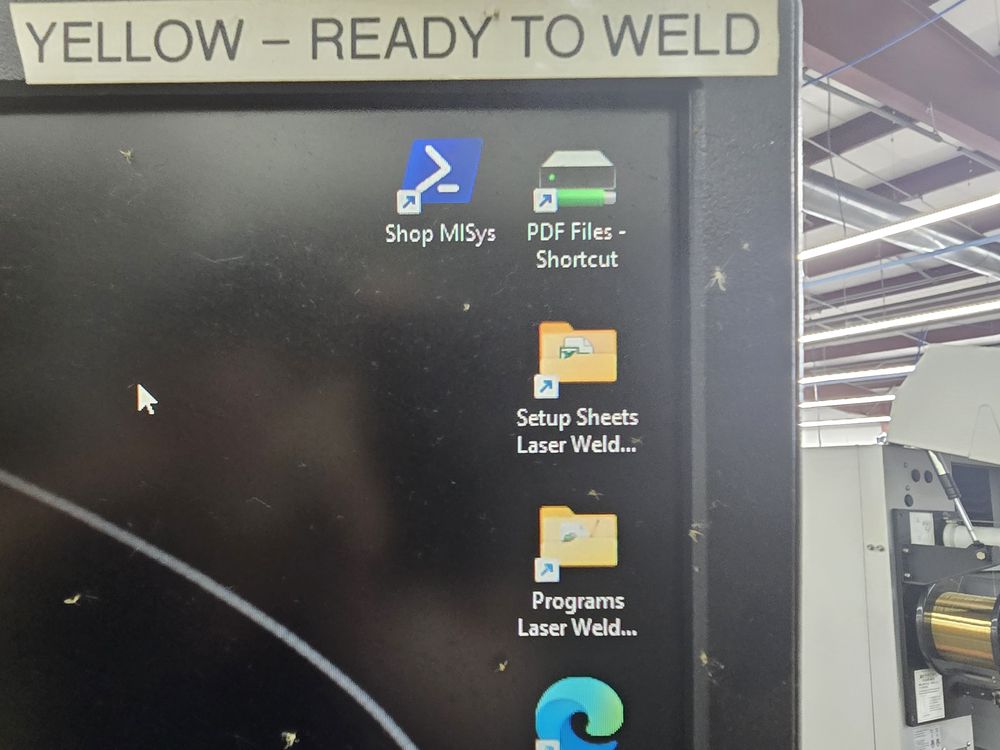 The shop office PC desktop with a folder shortcut named Setup Sheets Laser Weld.